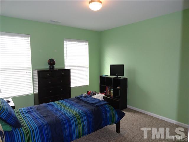 4705 Alenja Lane Raleigh, NC 27616 - Photo 13 of 15 a bedroom with a bed and a television