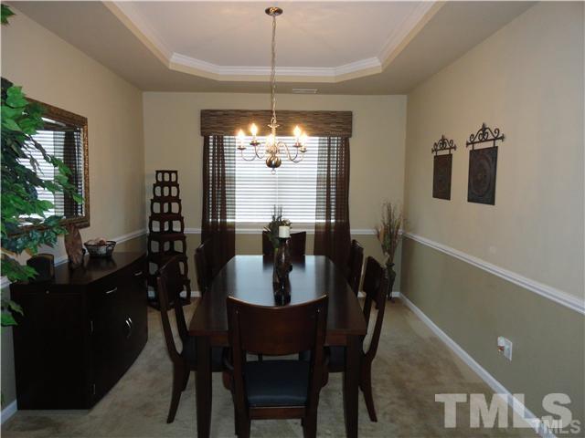 4705 Alenja Lane Raleigh, NC 27616 - Photo 3 of 15 a view of a dining room with furniture and chandelier