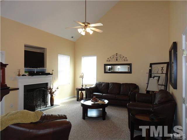 4705 Alenja Lane Raleigh, NC 27616 - Photo 8 of 15 a living room with furniture a fireplace and a flat screen tv