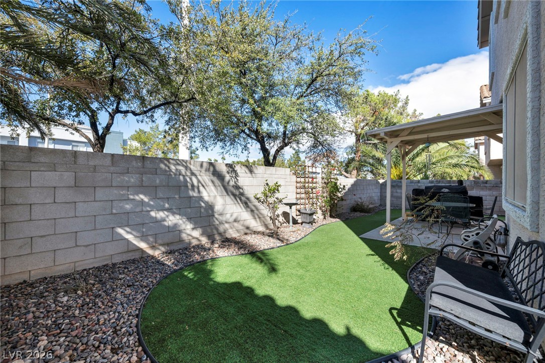 2132 Polynesia Circle Henderson, NV 89074 - Photo 23 of 25 Low-maintenance astroturf and a covered patio create the perfect outdoor space for relaxing or entertaining year-round.