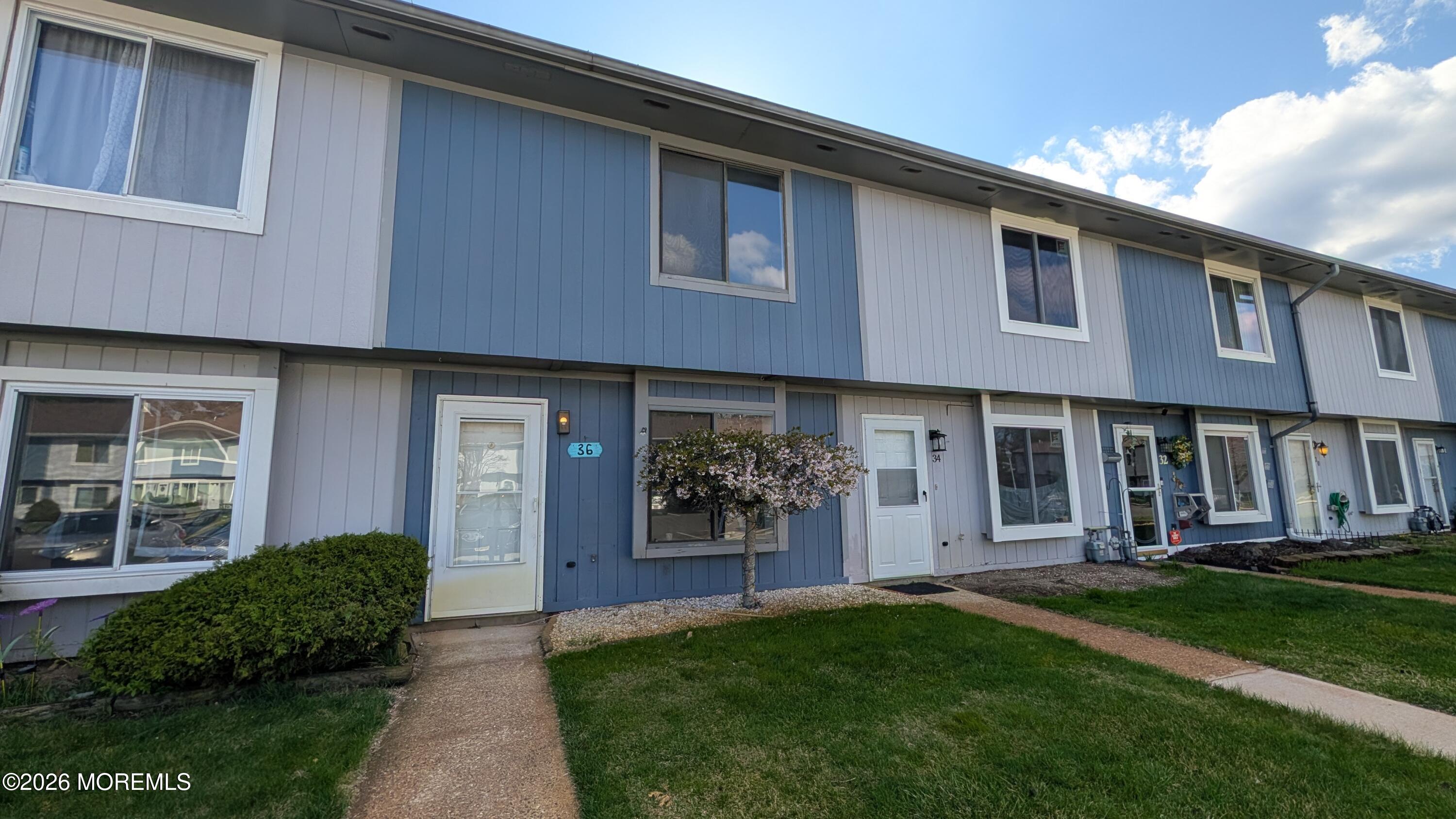 a front view of a house with a yard