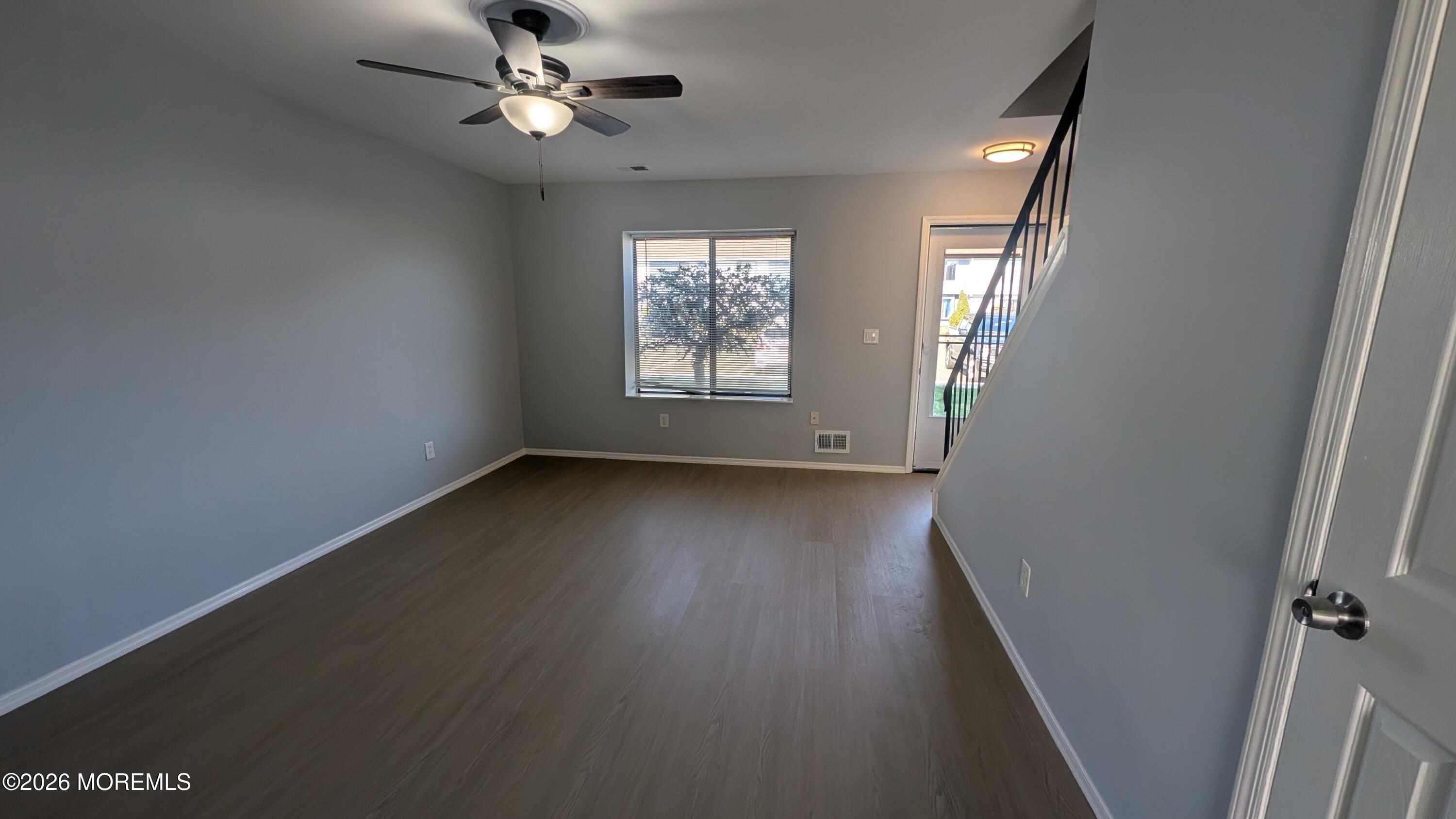 36 Creek Road, Unit 276 Brick, NJ 08724 - Photo 4 of 27 an empty room with wooden floor fan and windows