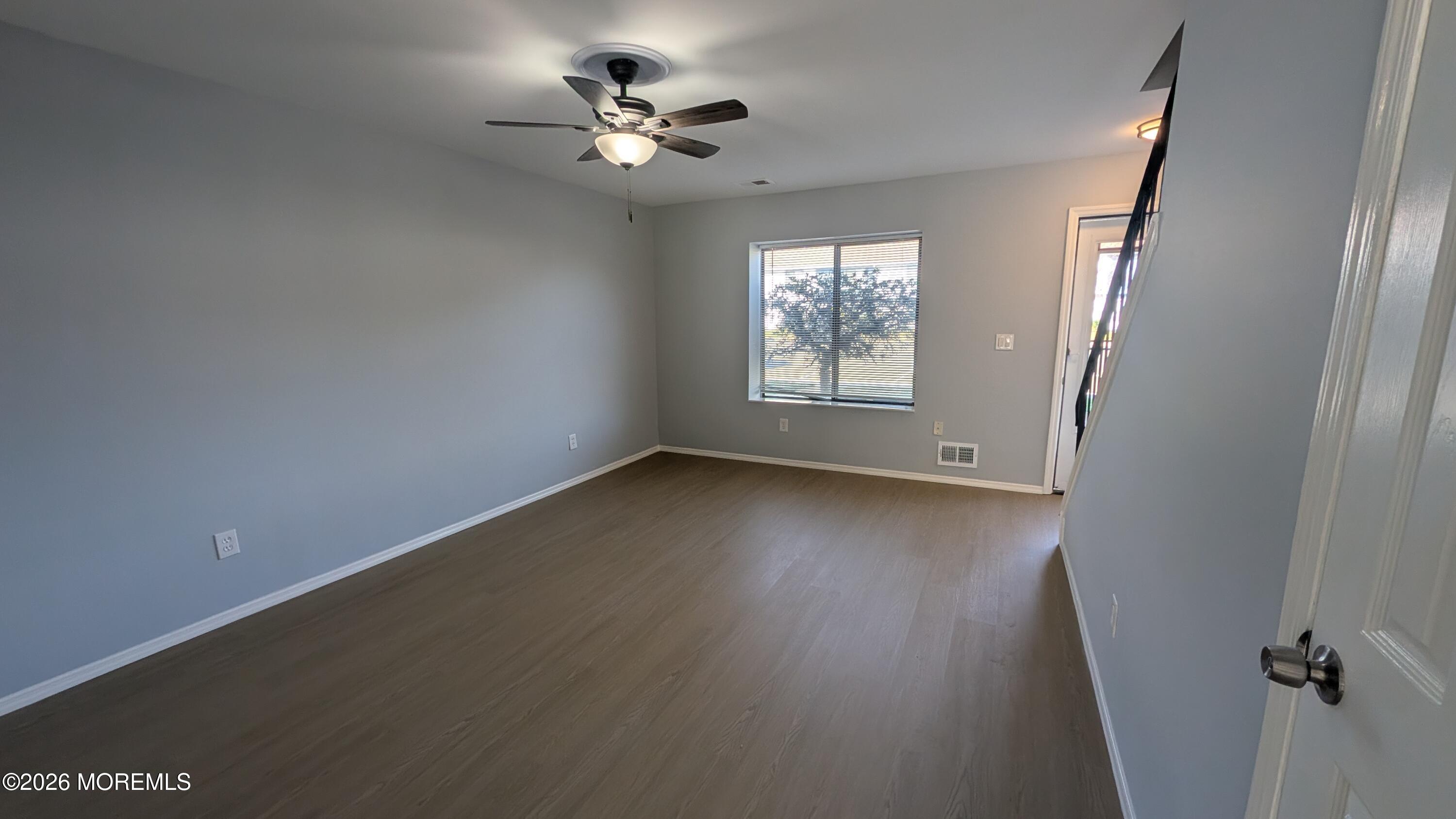 36 Creek Road, Unit 276 Brick, NJ 08724 - Photo 7 of 27 an empty room with wooden floor and windows