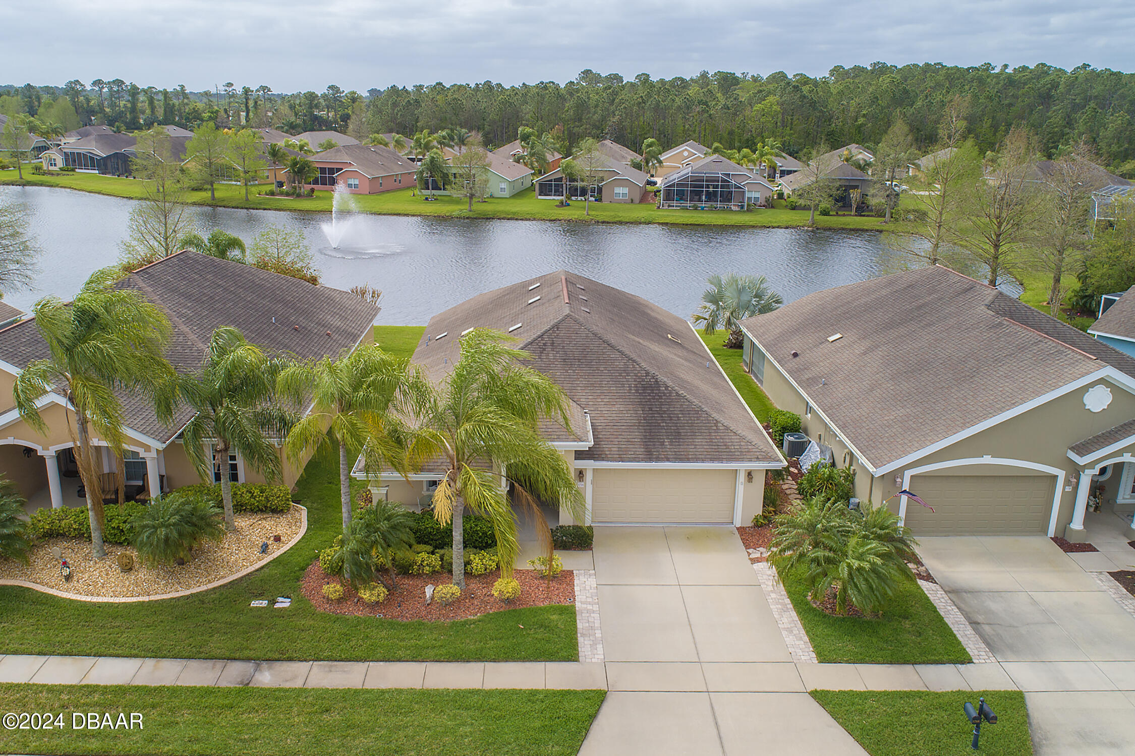 an aerial view of residential houses with outdoor space and lake view