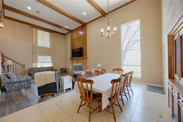 a view of a dining room with furniture and chandelier