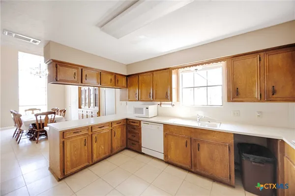 a kitchen with a sink and cabinets