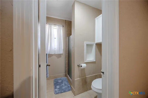 a bathroom with a glass door shower