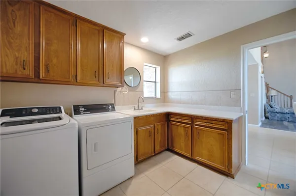 a kitchen with a stove top oven sink and cabinets