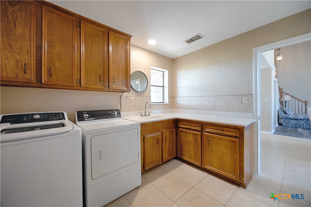 2745 Holub Road Schulenburg, TX 78956 - Photo 18 of 45 a kitchen with a stove top oven sink and cabinets