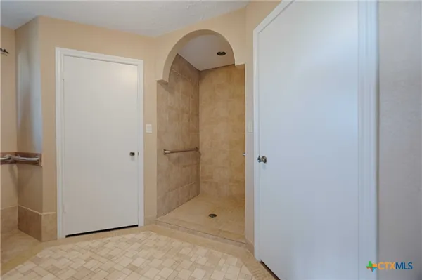 a bathroom with a granite countertop sink and shower