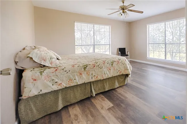 a bed sitting in a bedroom next to a window