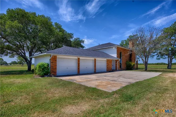 a front view of house with yard and trees