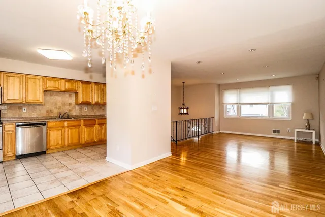 a view of a kitchen with granite countertop a sink and a stove top oven