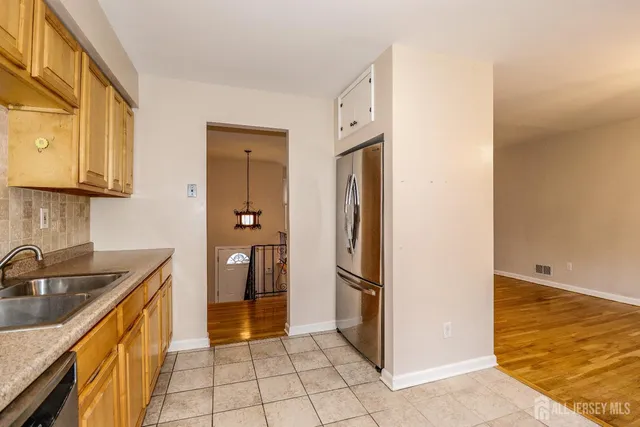a kitchen with a refrigerator and a sink