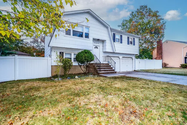 a view of a house with backyard and sitting area