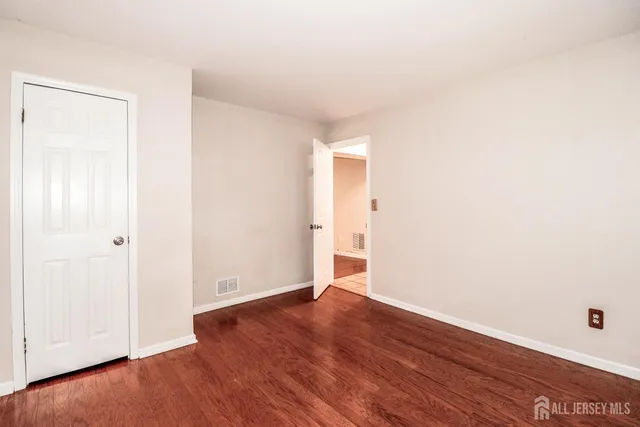 an empty room with wooden floor