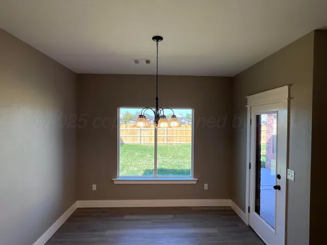 a room with a window and wooden floor