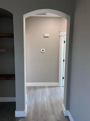 an empty room with wooden floor and closet