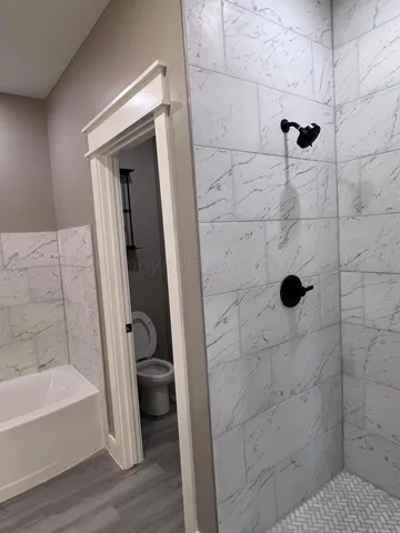 a bathroom with a bathtub and a shower