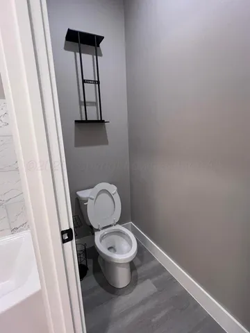 a white toilet sitting next to a small sink