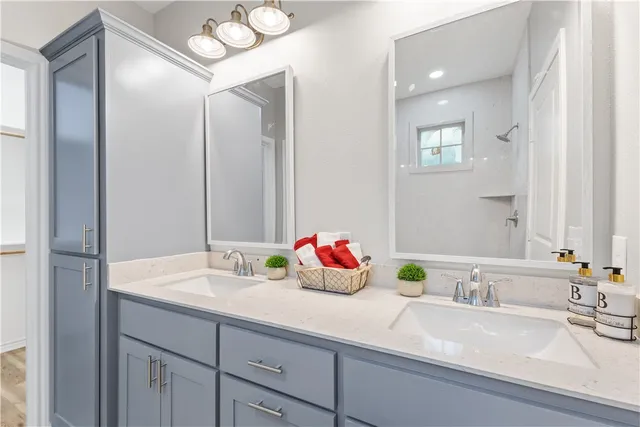a bathroom with a sink double vanity and a mirror