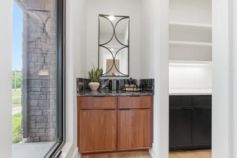 a spacious bathroom with a double vanity sink a large mirror and a bathtub