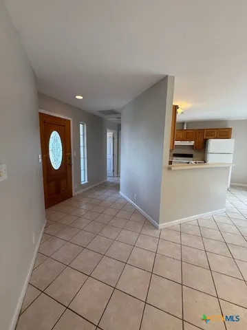a view of a livingroom with wooden floor and a large window