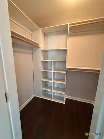 a view of walk in closet with empty racks