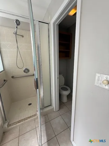 a bathroom with a granite countertop shower and a sink