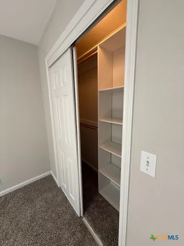 a view of closet area with empty racks