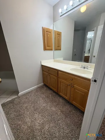 a bathroom with a sink a mirror and a vanity