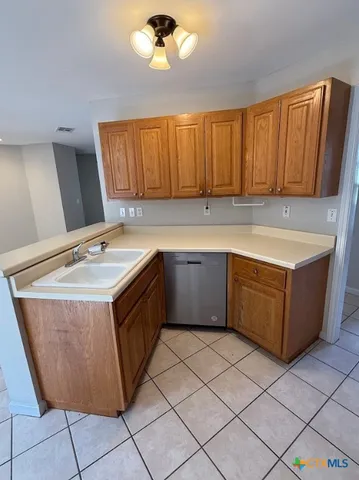 a kitchen with a sink window and cabinets