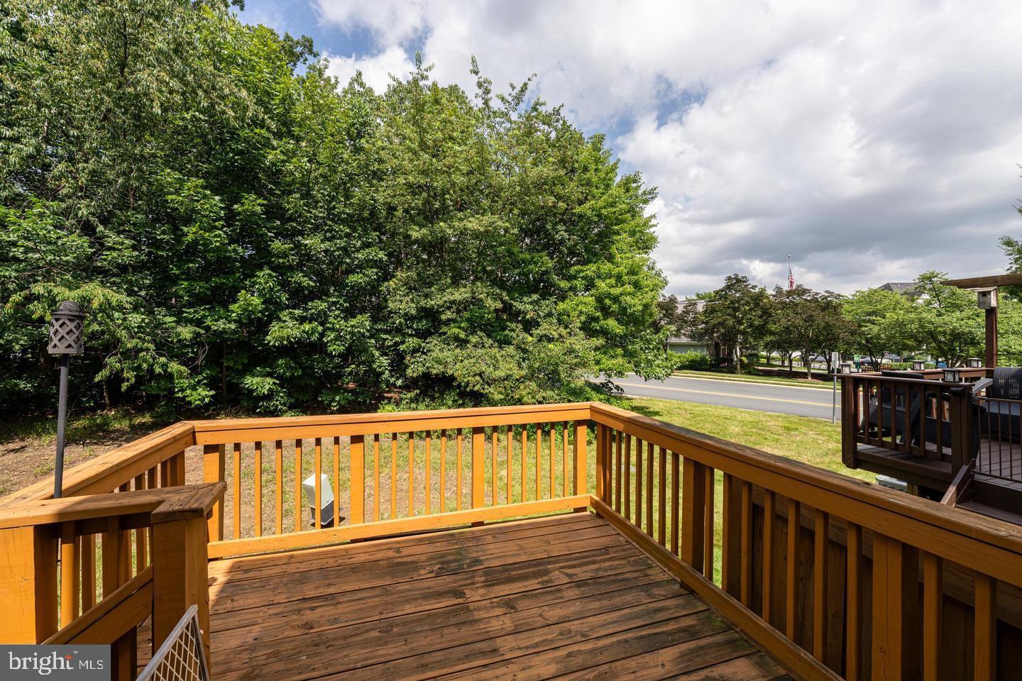 43122 Forest Edge Square Broadlands, VA 20148 - Photo 23 of 24 a view of a balcony with wooden floor and fence