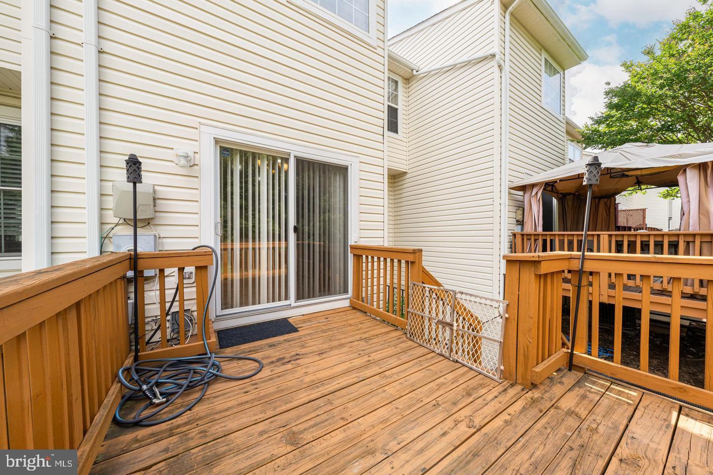 43122 Forest Edge Square Broadlands, VA 20148 - Photo 24 of 24 a view of a deck with wooden floor and fence next to a yard