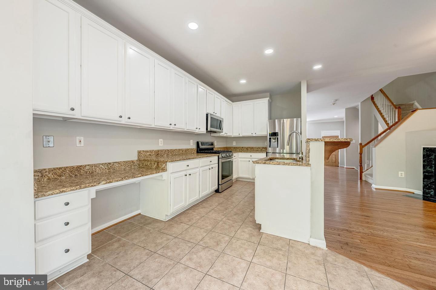 43122 Forest Edge Square Broadlands, VA 20148 - Photo 6 of 24 a kitchen with cabinets and white appliances