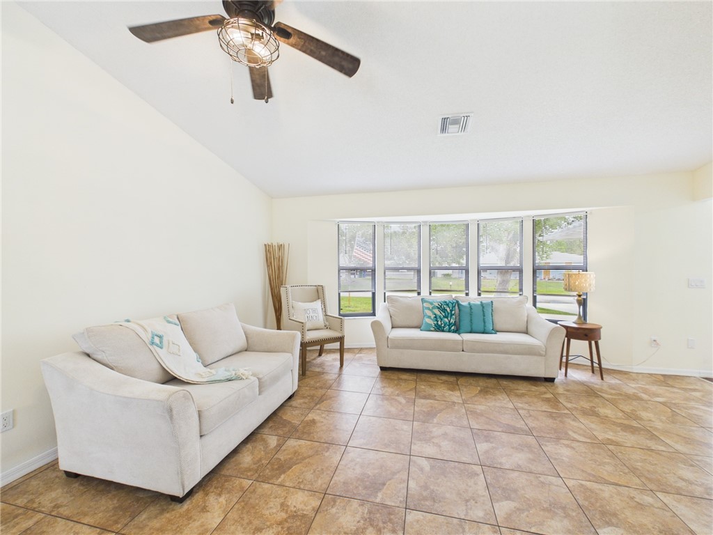225 Midvale Terrace Sebastian, FL 32958 - Photo 5 of 25 a living room with furniture and a large window