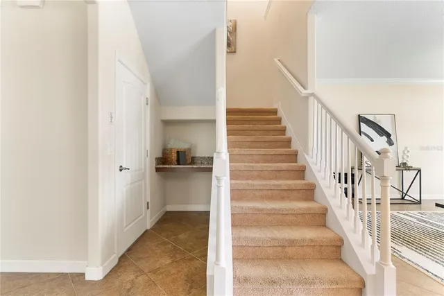 a view of a hallway with white walls and entryway