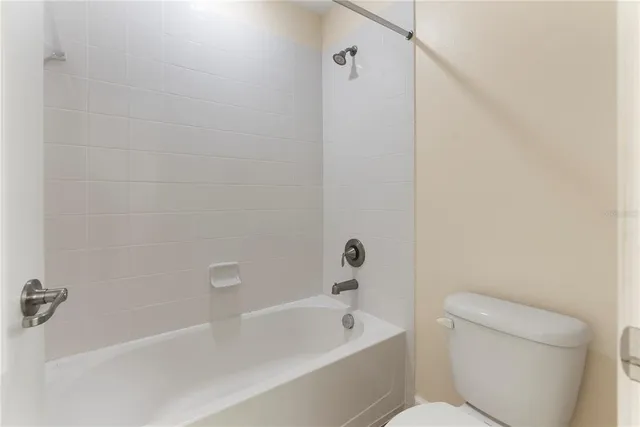 a bathroom with a toilet and bathtub