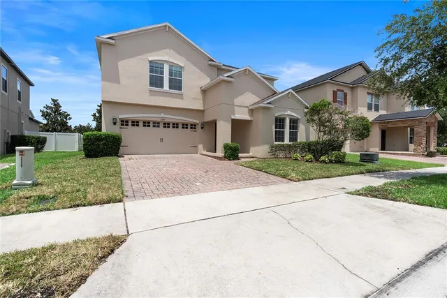 a front view of white house with a yard