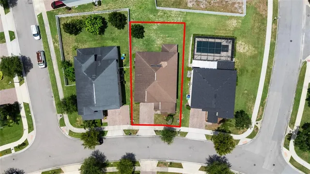 an aerial view of residential houses with outdoor space and river