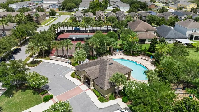 an aerial view of residential houses with outdoor space and river