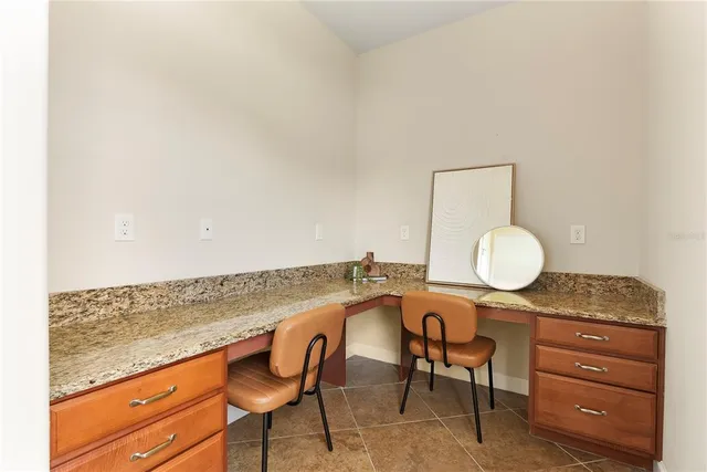 a living room with granite countertop chairs and a sink