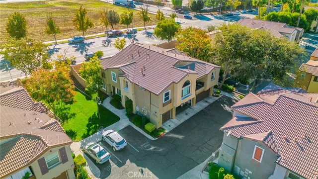 an aerial view of residential houses with outdoor space and river