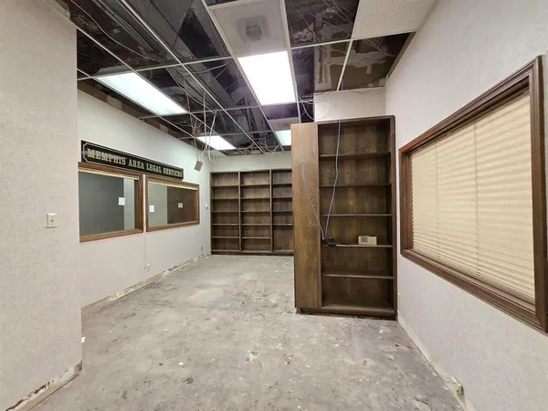 a view of an empty room with furniture and storage