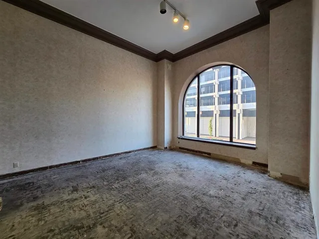 a view of a room that has a wooden door and a window