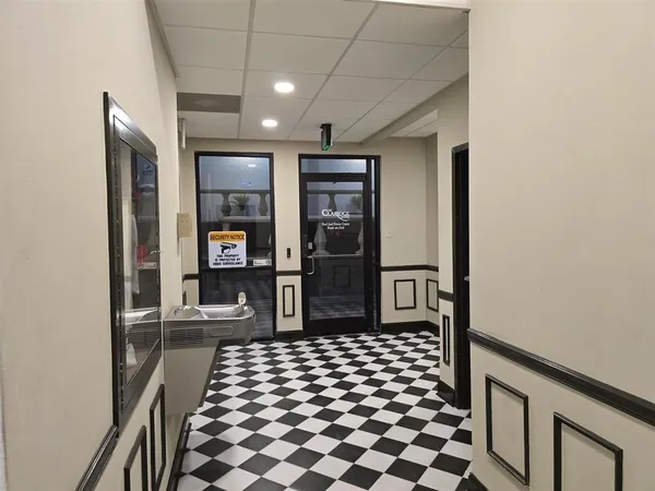 a bedroom with a bed and walk in closet with wooden floor