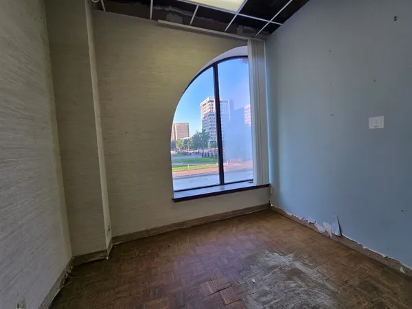 a view of a room that has a wooden door and a window