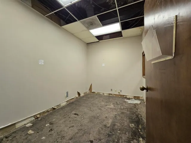 a view of a room with an empty space and a window