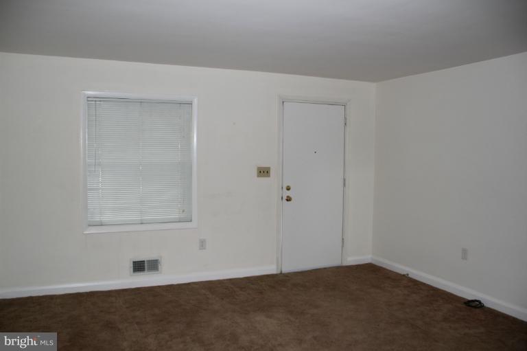 2211 Hawthorne Road Baltimore, MD 21220 - Photo 5 of 10 an empty room with a empty space and window