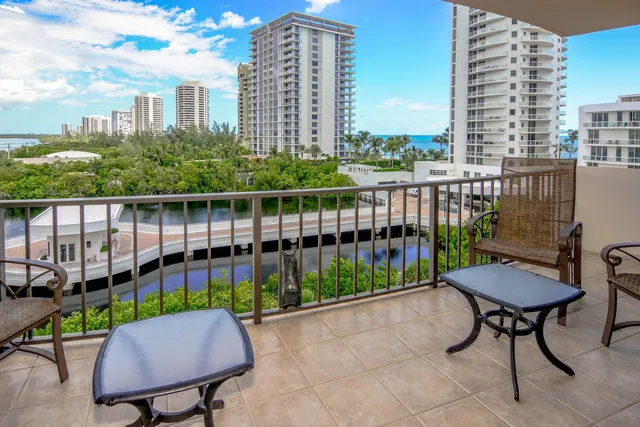 a view of a balcony with two chairs and a table